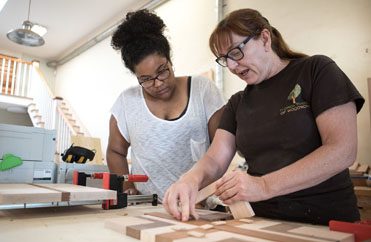 Student with Kate woodworking classes, black woodworker